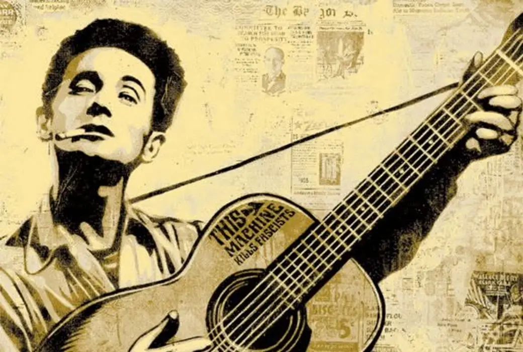 Woody Guthrie 與他那把寫著「This machine kills fascists」的吉他。